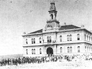 Students and  teachers pose in front of the school about 1885